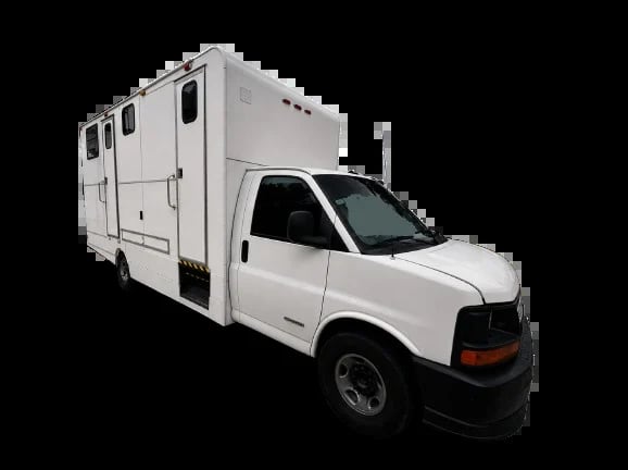 White pickup truck with attached camper box on black background