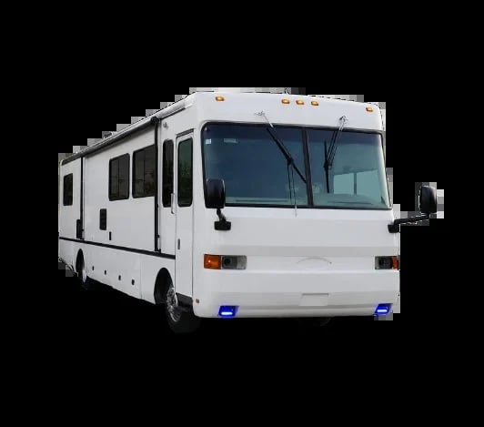 White recreational motorhome with multiple windows and slide-out section photographed against black background