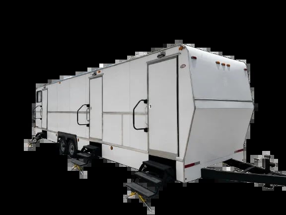 White travel trailer with dual entry doors and hitch, isolated against black background