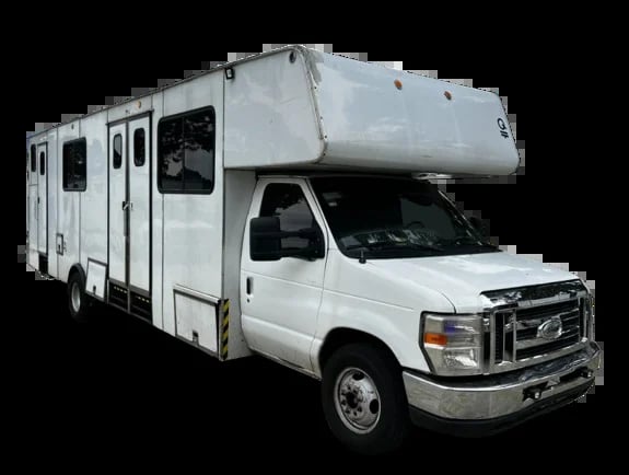 White Class C motorhome RV with cabover sleeping area on a Ford chassis, isolated on black background